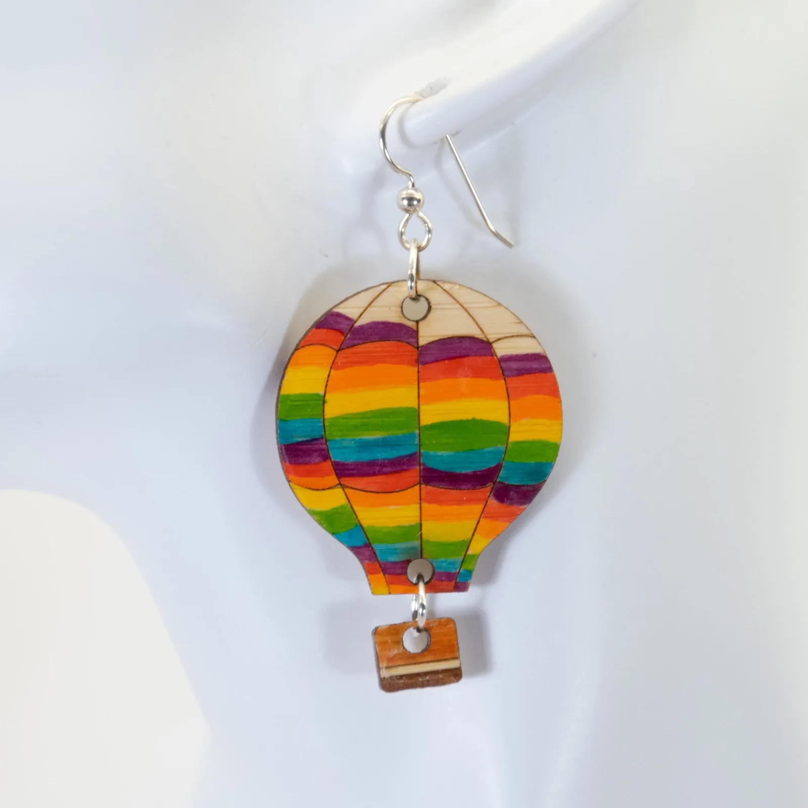 A rainbow-colored laser-cut hot-air-balloon earring