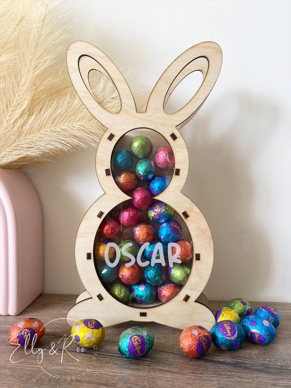 A personalized wooden Easter Bunny egg holder filled with chocolates