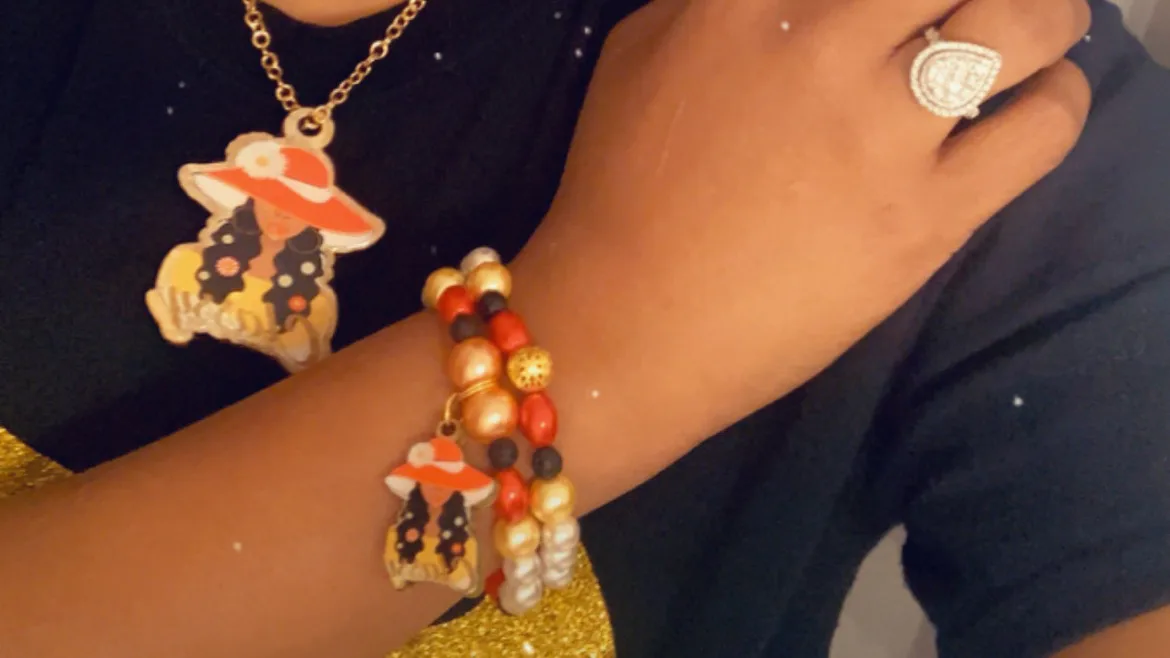 A matching necklace and charm bracelet created by Shalamar Newson