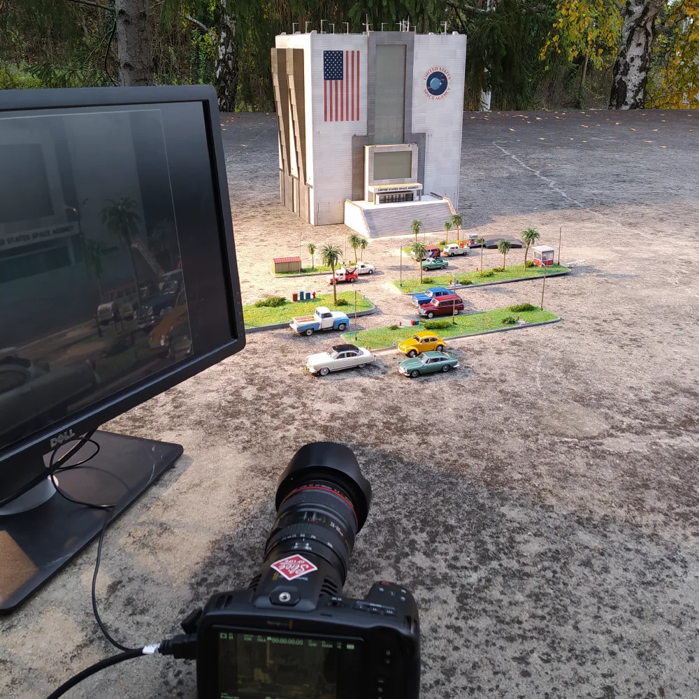 A camera filming the completed miniature set outdoors