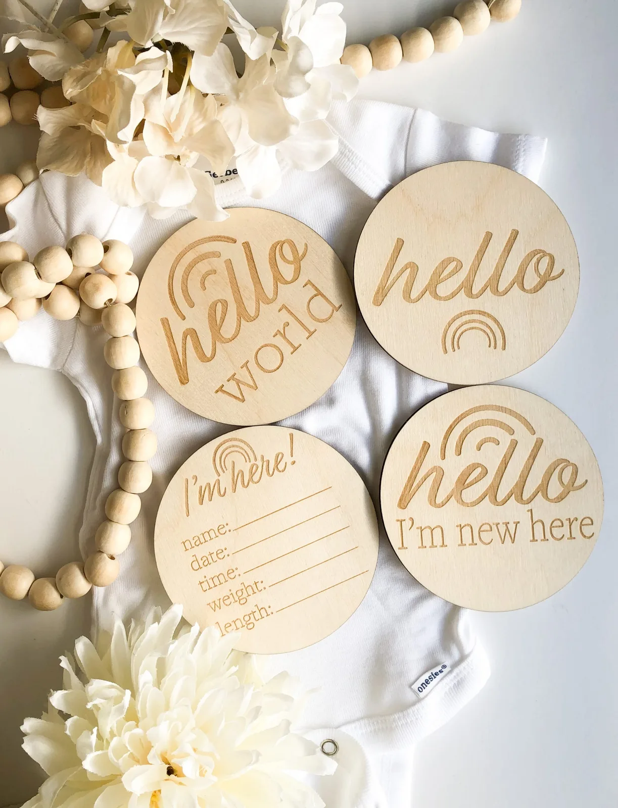 Four round wooden newborn announcement and milestone markers