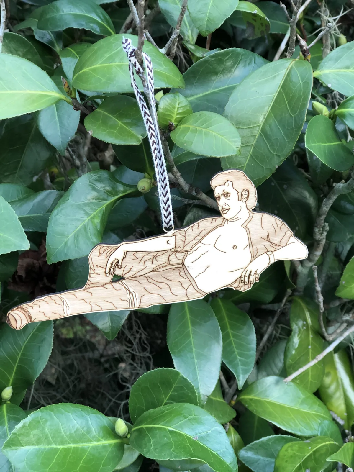 A laser-engraved wooden character ornament made by Goldcoin Creations