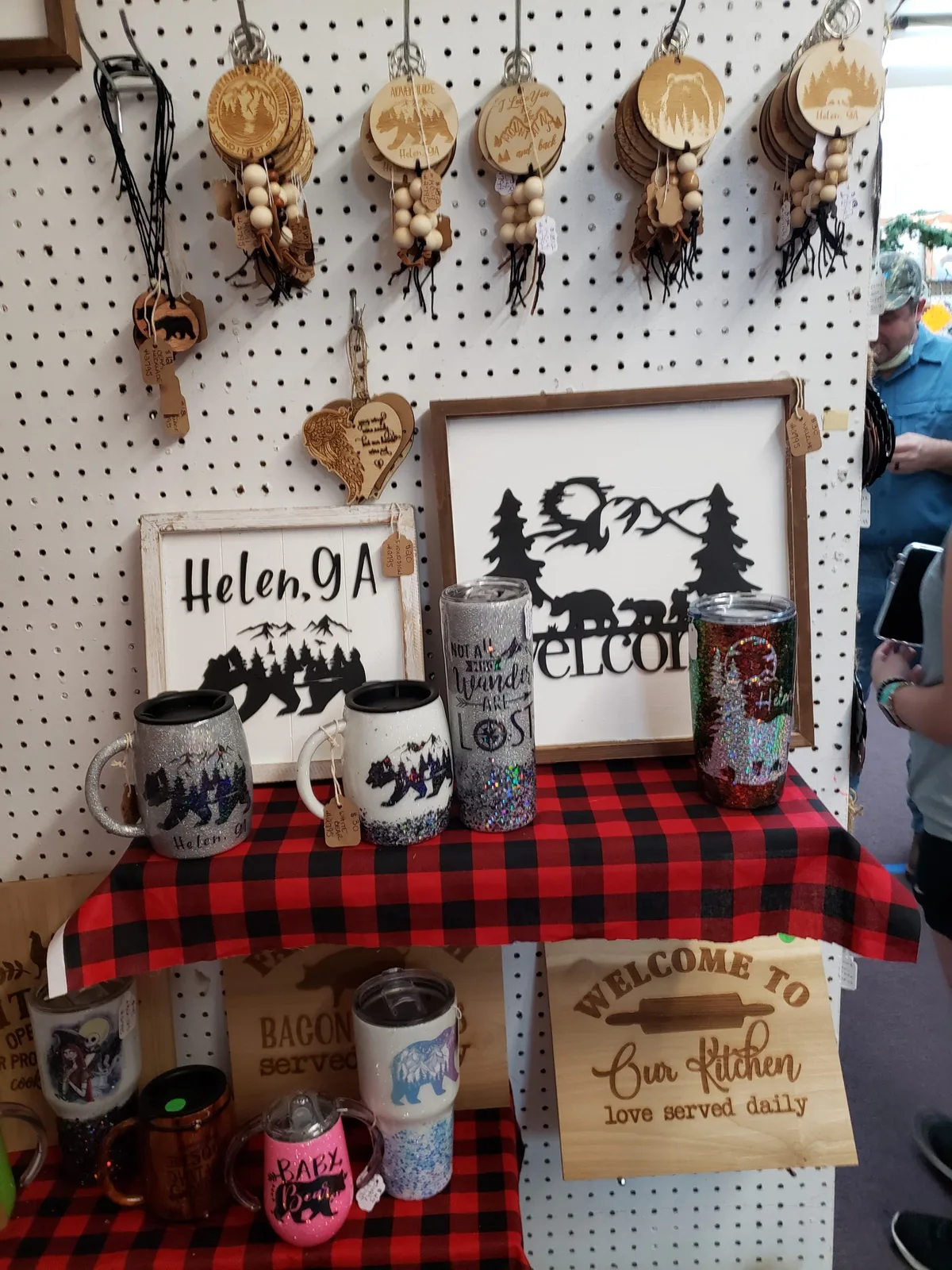Michele's display of laser-cut ornaments, signs, drinkware, and gifts