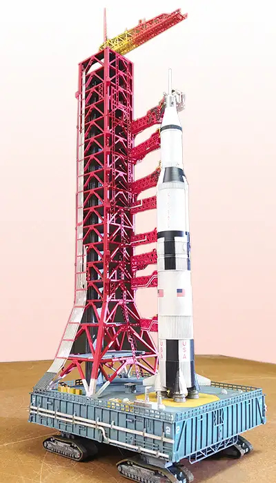 A laser-cut scale model of a rocket standing on its launch tower
